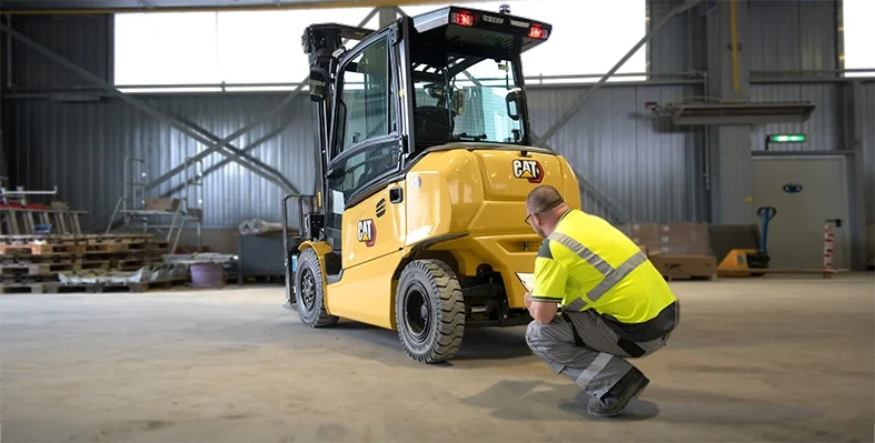 An engineer checking a Cat lift truck.