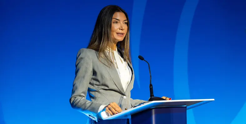 Lara Sidawi Moore speaking at a podium