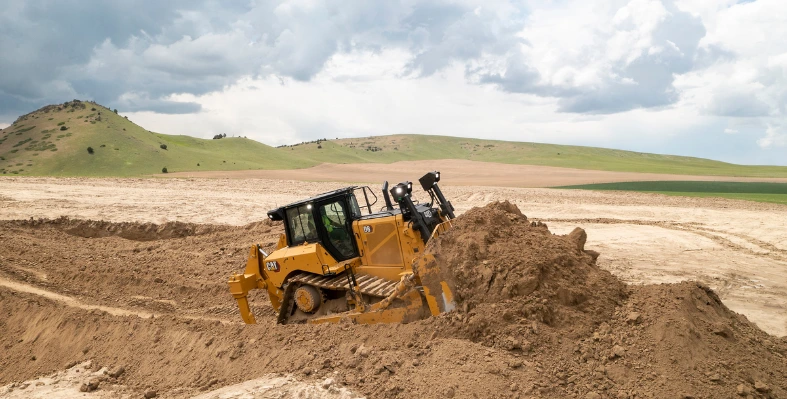 A bulldozer operating in an open field