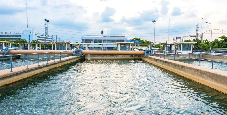 Water treatment facility with large pipes and filtration pools.