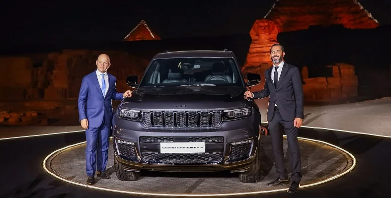 Two senior stakeholders standing next to the new Jeep Grand Cherokee L at the unveiling.