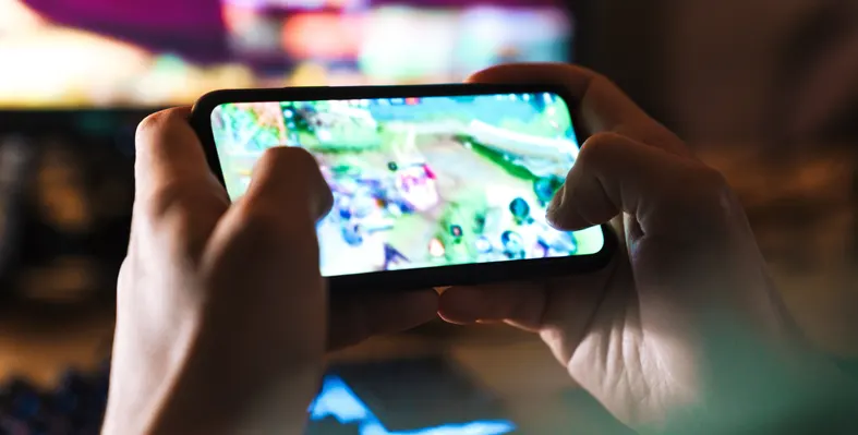 Man playing video game on mobile phone