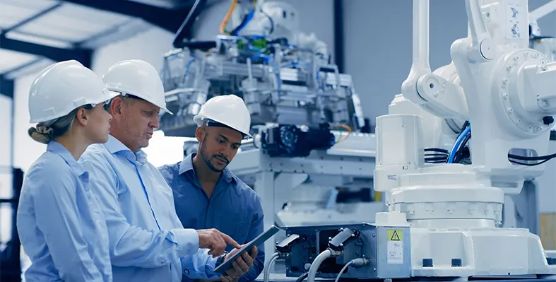 Three_manufacturing_workers_looking_at_the_tablet's_screen