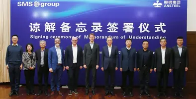 A few men and one woman standing in front of a blue background