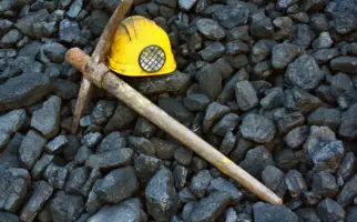 A pickaxe and helmet symbolic of mining industry.