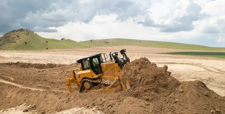 A bulldozer operating in an open field