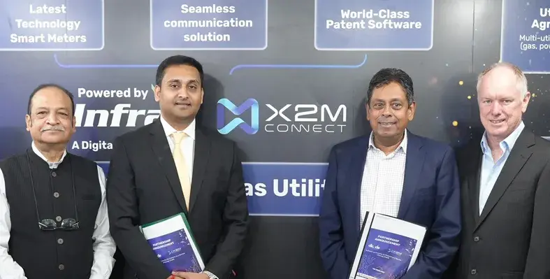 Four executives posing for a photo at a partnership announcement event.