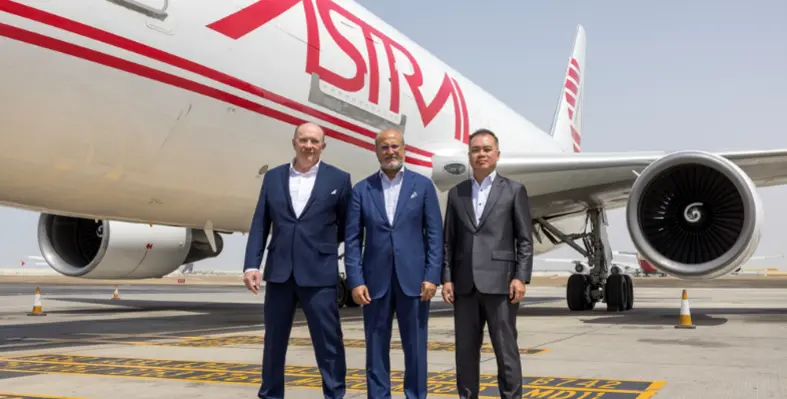 Key leaders from Astral Aviation and Etihad Cargo standing in front of an Astral aeroplane. 