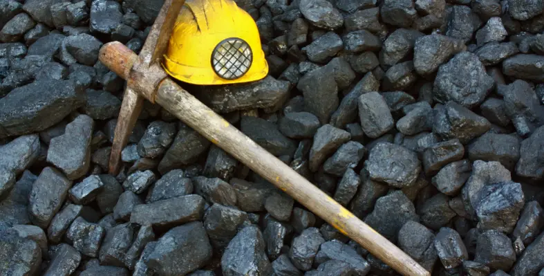 A pickaxe and helmet symbolic of mining industry.